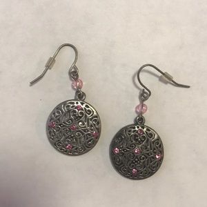 Circular silver colored earrings with pink accent